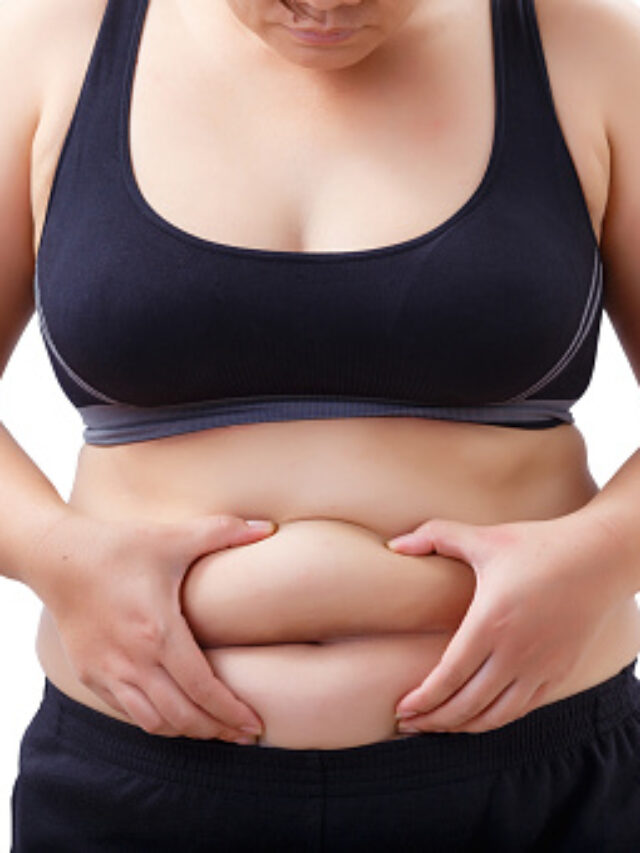 fat woman looking and touching her stomach